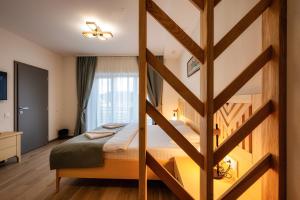 a bedroom with a large bed with a wooden wall at Villa Alpina Borsec in Borsec