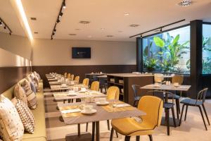 a row of tables and chairs in a restaurant at Eurostars Villa Itziar in San Sebastián