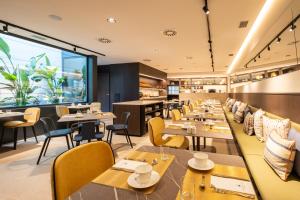 a restaurant with tables and chairs and a large window at Eurostars Villa Itziar in San Sebastián