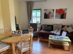 a living room with a table and a couch at Haus Maja in Kurort Rathen