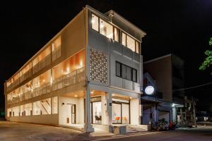 a building with a clock on the side of it at 消波塊民宿 in Xiaoliuqiu +131 photos