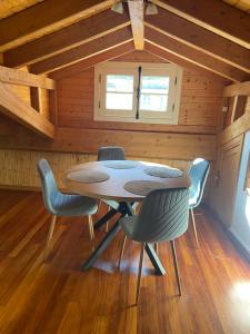 a dining room with a table and chairs in a cabin at Ático Seijas 6 in Tui +12 photos