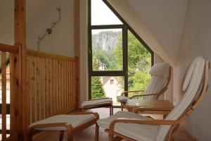 a room with three chairs and a large window at Haus Maja in Kurort Rathen