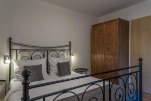 a bedroom with a bed and a wooden cabinet at Haus Maja in Kurort Rathen