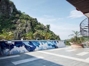 a resort with a mountain in the background at catba new city hotel in Cat Ba