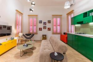 a living room with green cabinets and a couch at DAR MEMOIR Apart Hotel in Al Mudawwar