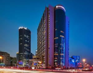 a tall building in a city at night at InterContinental Shanghai Pudong by IHG in Shanghai