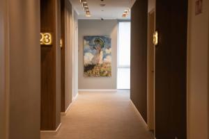 a hallway with a painting of a woman on the wall at Impresamente Art Hotel in Sofia