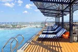 a row of chaise lounges on the top of a swimming pool at Sandals Everyday Hotel in Tuy Hoa
