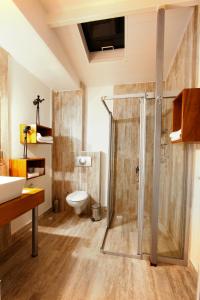 a bathroom with a shower and a toilet at Nur Hotel in Kaş
