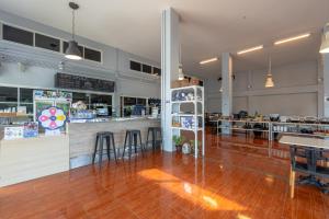 a large room with a bar and a restaurant at Kokotel Khao Lak Isara Casa in Khao Lak