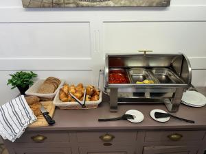 a kitchen counter with bread and other food on it at Hotel Le 5 in Martigues