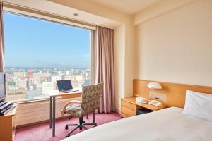 a hotel room with a bed and a desk and a window at Kushiro Prince Hotel in Kushiro +53 photos