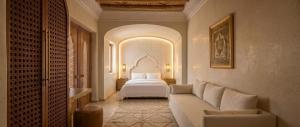 a hotel room with a bed and a couch at Riad Maison Palmier in Marrakesh +34 photos