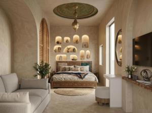 a bedroom with a bed and a couch and a tv at Riad Maison Palmier in Marrakesh
