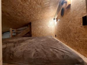 a bedroom with a bed in a stone wall at Apartament WERANDA in Paplin