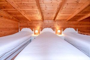 two beds in a wooden room with wooden ceilings at Dyne Resort in Jeju +122 photos