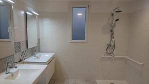 a white bathroom with two sinks and a shower at Le grand gîte de souels in Almayrac +25 photos