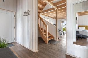a hallway of a home with a staircase and a bedroom at Ferienhaus Möwenkoje Olpenitz in Olpenitz