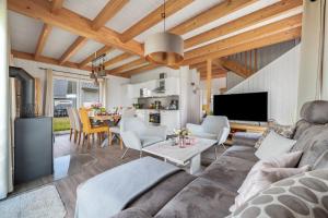 a living room with a couch and a table at Ferienhaus Möwenkoje Olpenitz in Olpenitz +22 photos