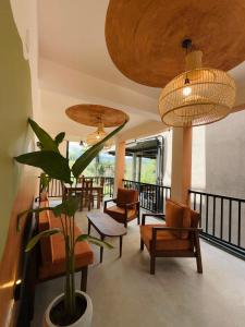 a living room with chairs and a potted plant at Crown Valley Boutique Lifestyle Hotel, Ella in Ella