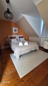 a bedroom with a large bed with two pillows at au fil de l'oust in Rohan +8 photos
