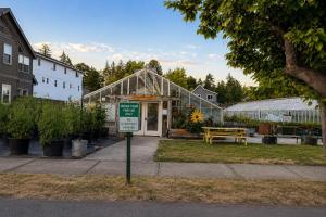 a green house with a sign in front of it at Kwem Homes in Salem