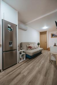 a living room with a couch and a refrigerator at Houses São Pedro in São João da Pesqueira