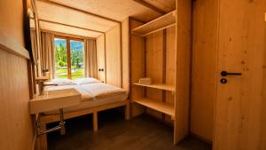 a small room with a bed and a window at ALPENHOF Mountain Lodge in Stechelberg