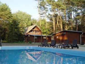 a group of chairs sitting next to a swimming pool at Ośrodek Świt Wilga in Wilga