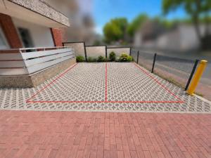 a tennis net on a brick sidewalk in front of a building at Pulheim Living 4 in Pulheim +1 photo