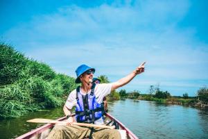 a man in a boat on a river at Kushiro Prince Hotel in Kushiro