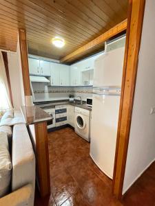 a kitchen with a refrigerator and a washer and dryer at Apartamento Uno in Guadalaviar +5 photos