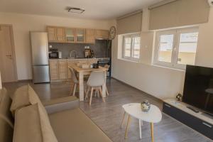 a kitchen and living room with a couch and a table at Casa Berardo in Megara
