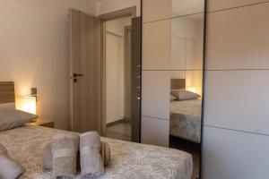 a bedroom with two beds and a mirror at Casa Berardo in Megara +5 photos
