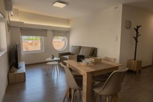 a living room with a wooden table and chairs at Casa Berardo in Megara