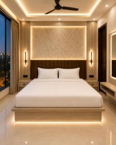 a bedroom with a large white bed and a window at Hotel La Serene in Agra +21 photos