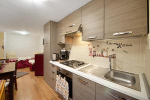 a kitchen with a sink and a stove top oven at L'archetto Valle d'Aosta in La Salle +15 photos