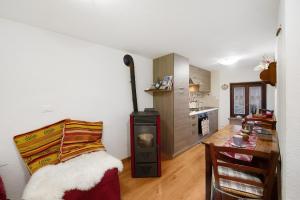a room with a kitchen and a bed in a room at L'archetto Valle d'Aosta in La Salle