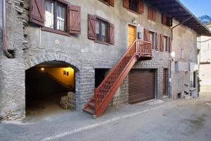 a building with a staircase on the side of it at L'archetto Valle d'Aosta in La Salle