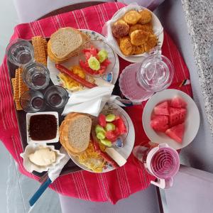 a plate of breakfast food on a red tray at Bujtina4A Rrenc in Renc