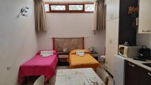 a small room with two beds and a microwave at Salentino in Lequile