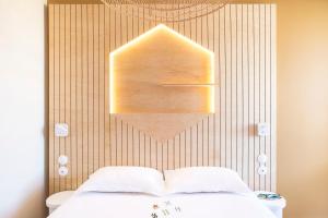 a bedroom with a bed and a wooden wall at Hôtel Life Marseille VP - Vieux Port in Marseille
