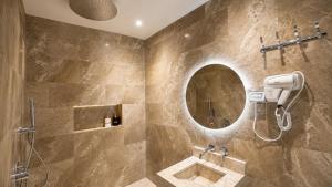 a bathroom with a shower and a mirror at Albazar Residence Salalah in Salalah +32 photos