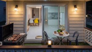 a backyard patio with a grill and a table with a table at Chuncheon Happysday Pet-Friendly Pension in Chuncheon