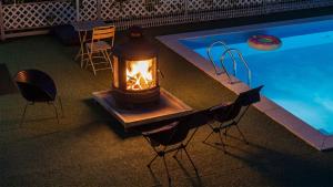 a table with a lantern next to a swimming pool at Chuncheon Happysday Pet-Friendly Pension in Chuncheon