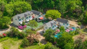 an aerial view of a house with a yard at Chuncheon Happysday Pet-Friendly Pension in Chuncheon