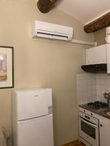 a kitchen with a white refrigerator and a stove at Gite des Ocres in Villars