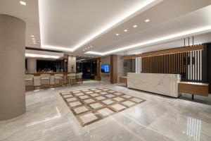 a lobby with a reception desk and a bar at Creta Palm Resort Hotel & Apartments in Stalos