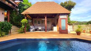 a swimming pool in front of a house with a gazebo at Villa Ayutthaya, Private Pool Near Kantiang Beach in Ko Lanta